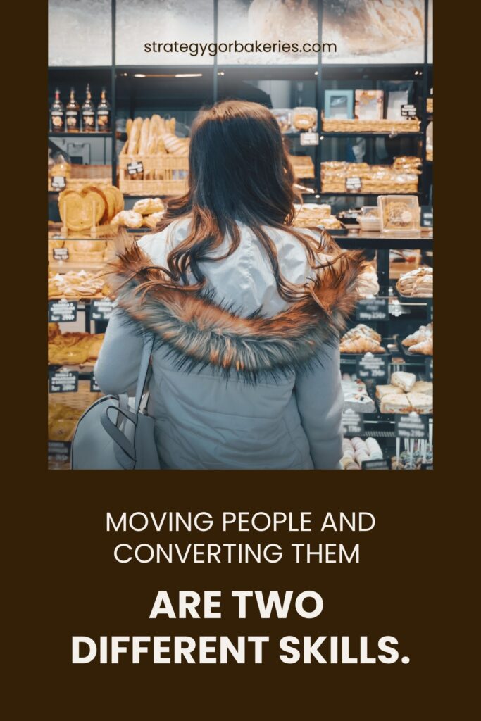 Customer standing in front of a bakery display case filled with bread and pastriesBakery Branding Storytelling.