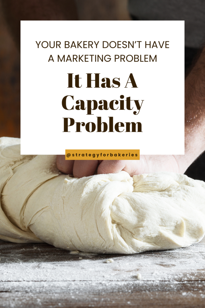 Hands kneading dough on a floured surface with text: Your bakery doesn’t have a marketing problem It has a capacity problem @strategyforbakeries.