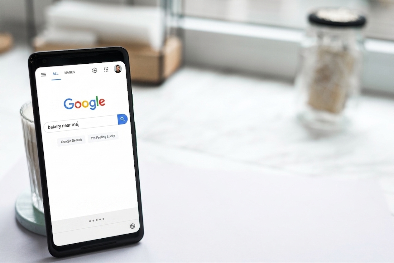 Smartphone showing a "bakery near me" Google search, illustrating digital marketing for bakeries and how customers discover them online.